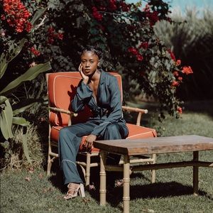 Navy blue jumpsuit with white stripe details.